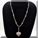 J128. Gold tone beaded necklace with diamond heart pendant hanging from 3 pave diamond beads.